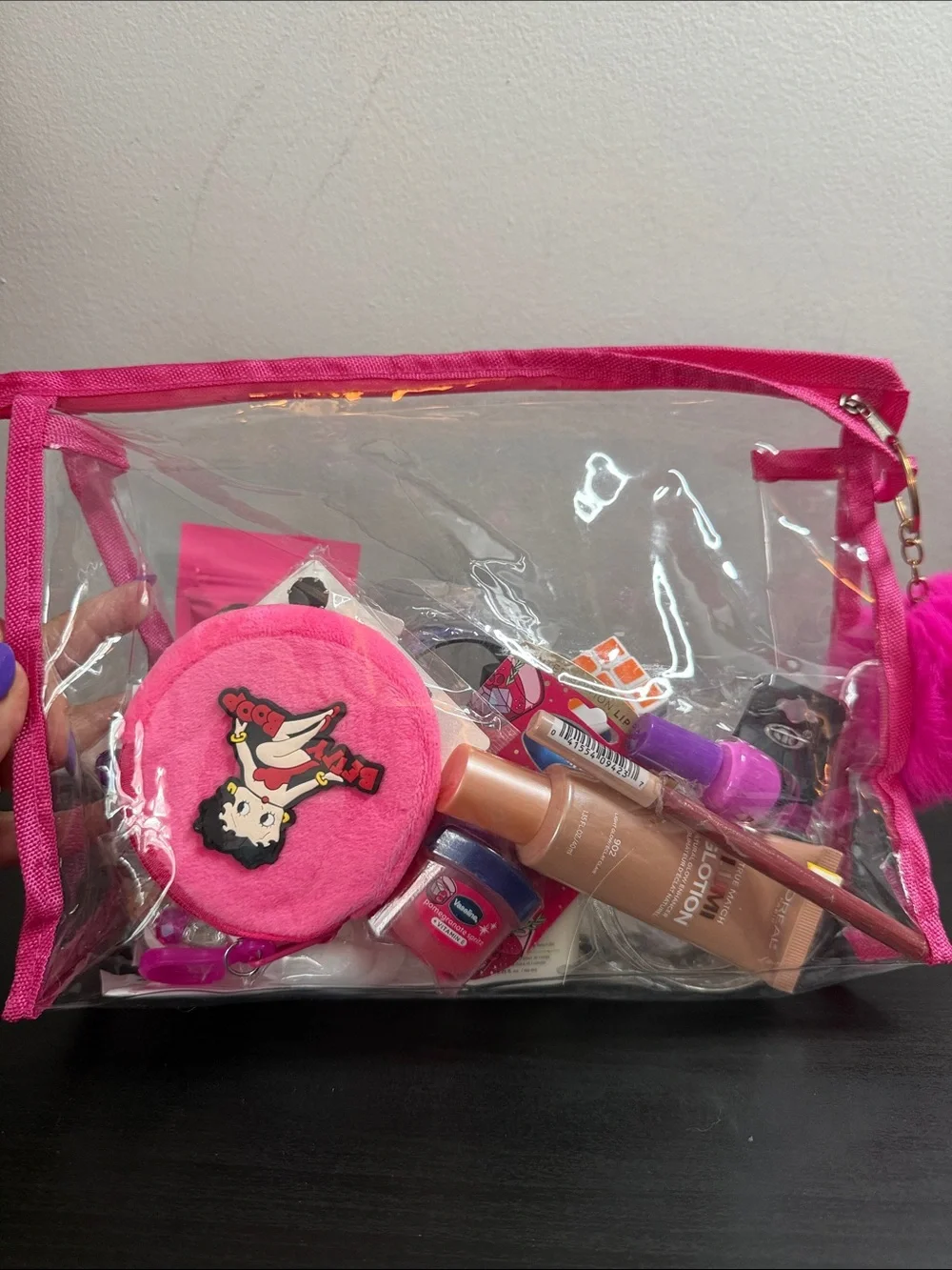 Clear Cosmetic Pouch with Hot Pink Trim and Pom Charm filled with goodies